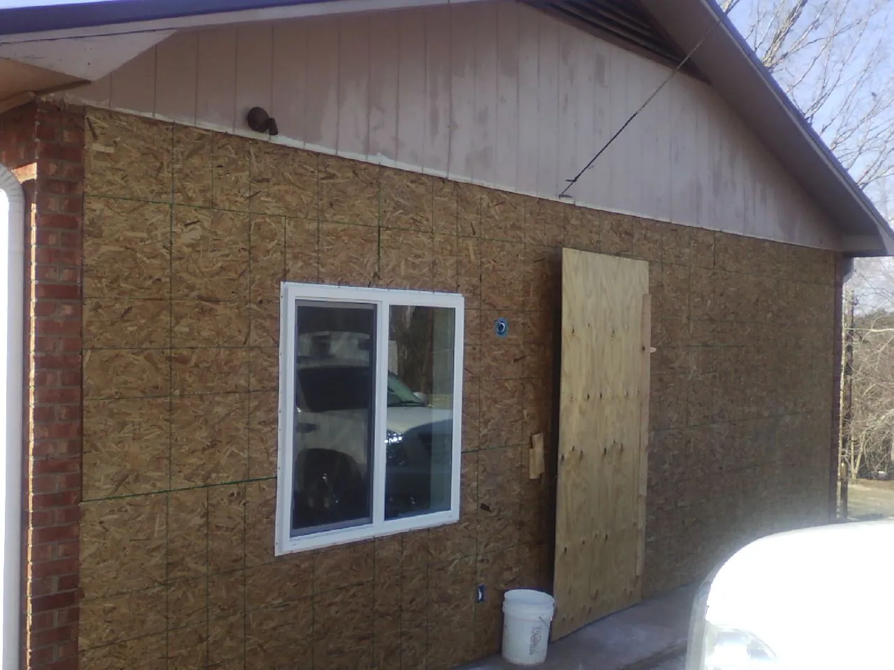 OSB sheathing on a garage addition wall before siding in Memphis